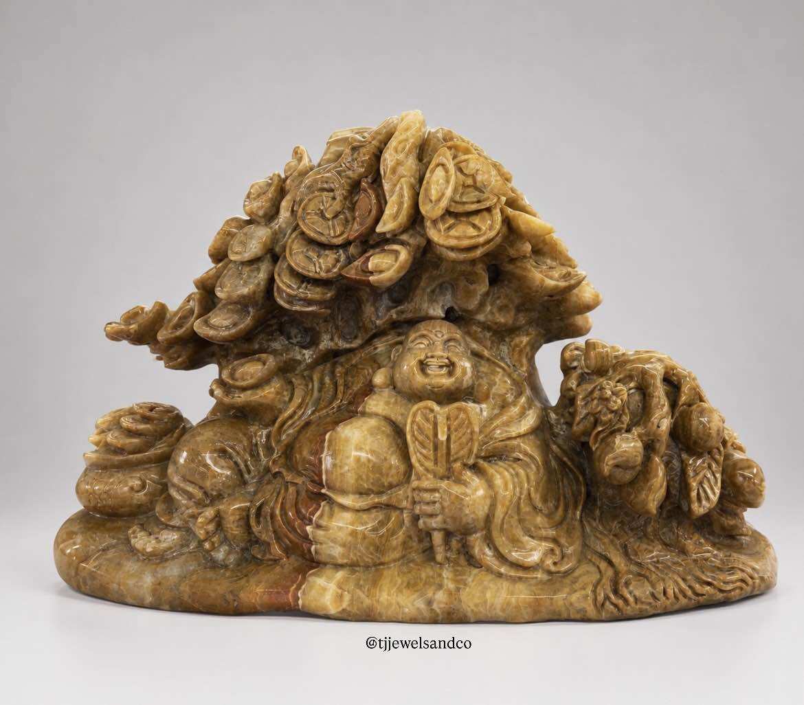 Budai Beneath the Money Tree |   Carved Image of the Buddha under the Silver Tree and Gold Tree, Burmese Yellow Stone. |   Width 18.5 Inches, Height 12 Inches.