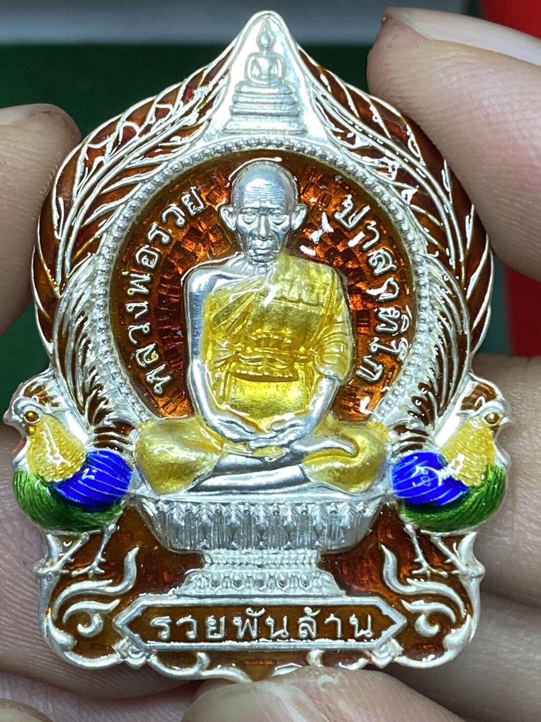 # Amulet # Authentic Buddha # Luang Pho Rak, a Billionaire, Luang Pho Rak Foundation, Year 64 
 Silver Body with Red Enamel Throughout. Red Label, Complete Box, Worship, Trade, Prosperity. # # Luang Pho Rak, a Billionaire, Luang Pho Rak Foundation, Year 6 - ยี่ห้อ มงคลรํ่ารวย ราคา 2,000 บาท*ส่งฟรี